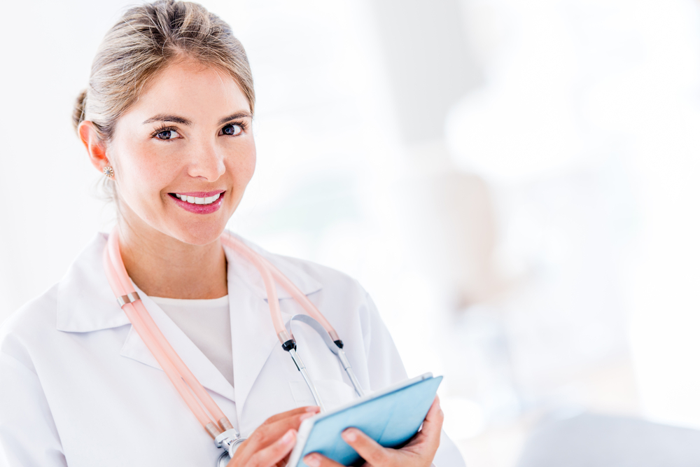 Female doctor using her tablet computer at the hospital